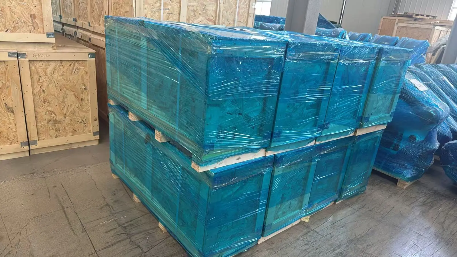 Eight upgraded hydraulic breakers packed and protected for export